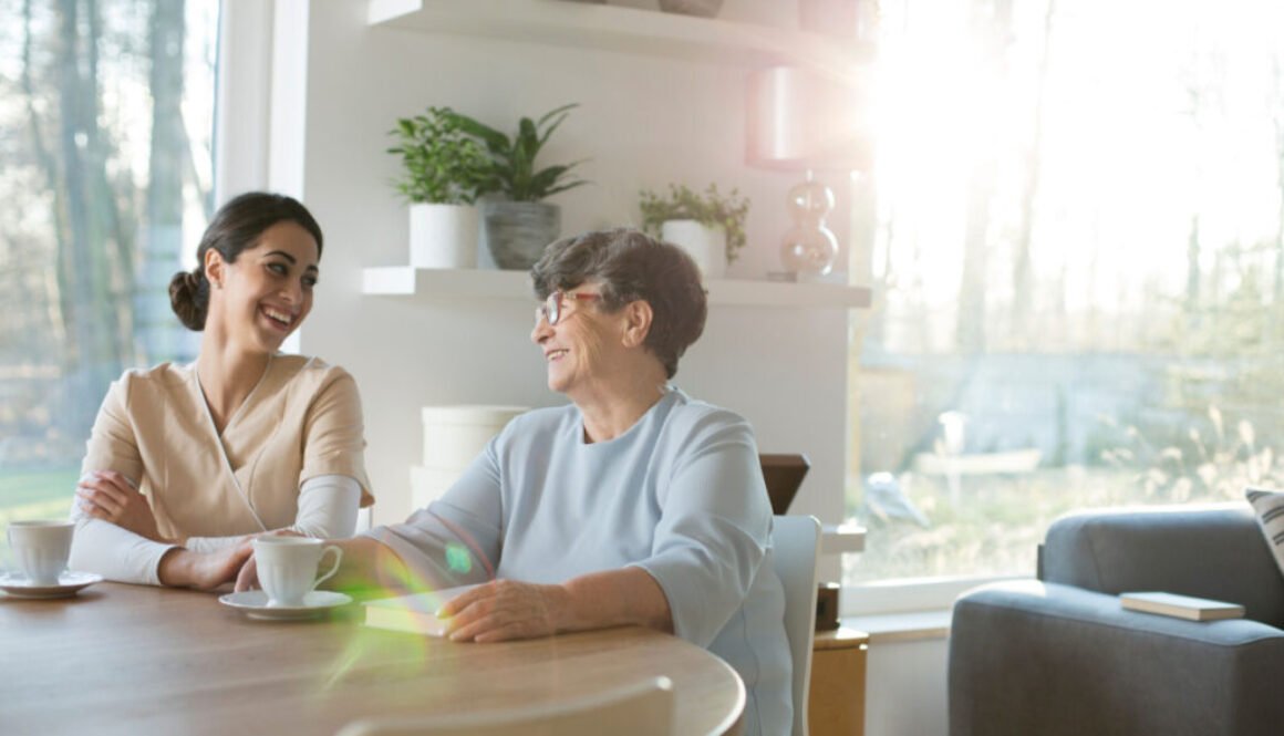 Two women enjoying coffee and conversation at home.