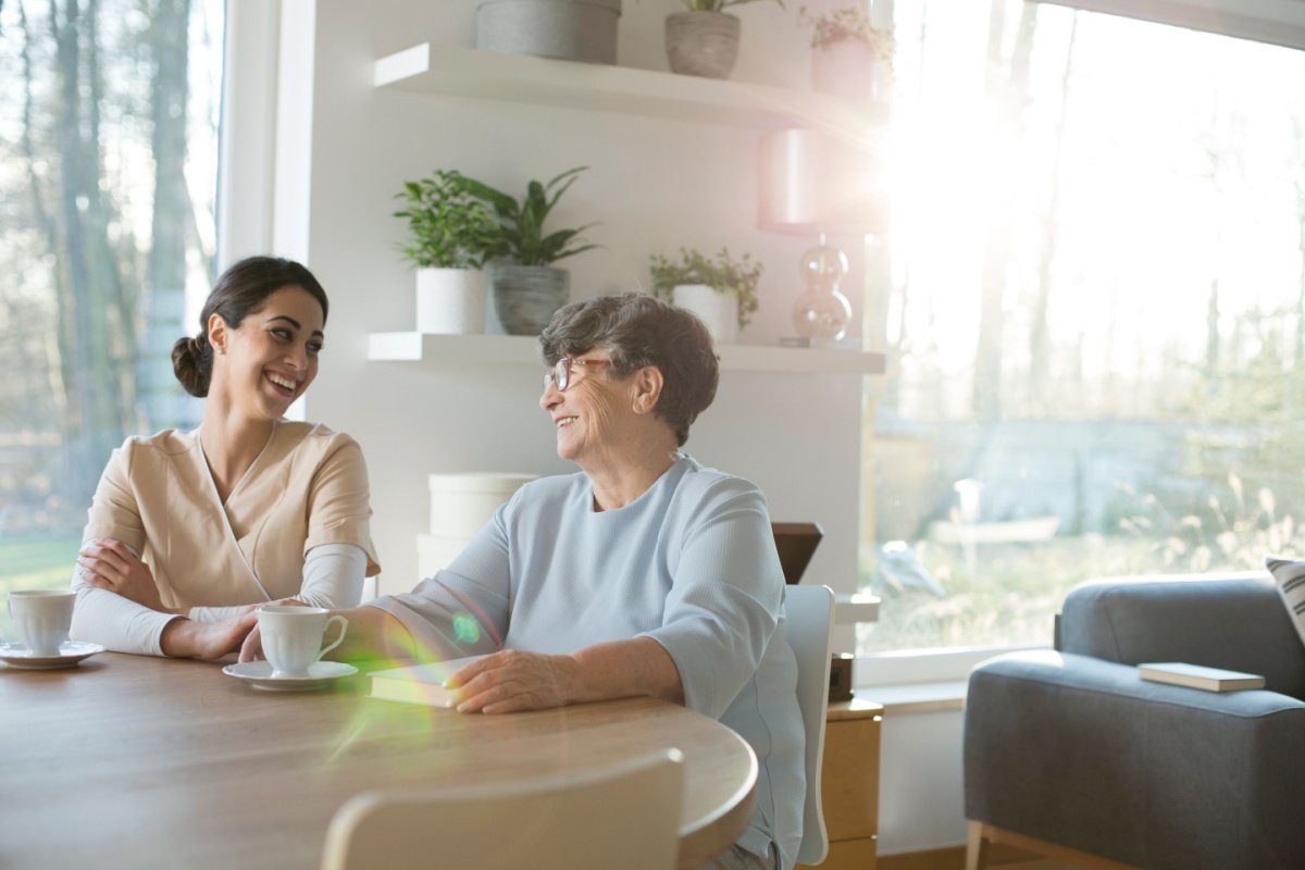 Two women enjoying coffee and conversation at home.