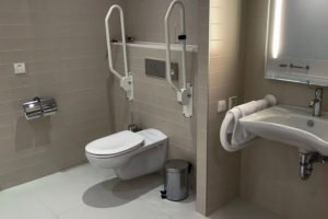 Accessible restroom with supportive grab bars.