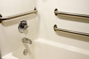 Accessible bathtub with grab bars and faucet.