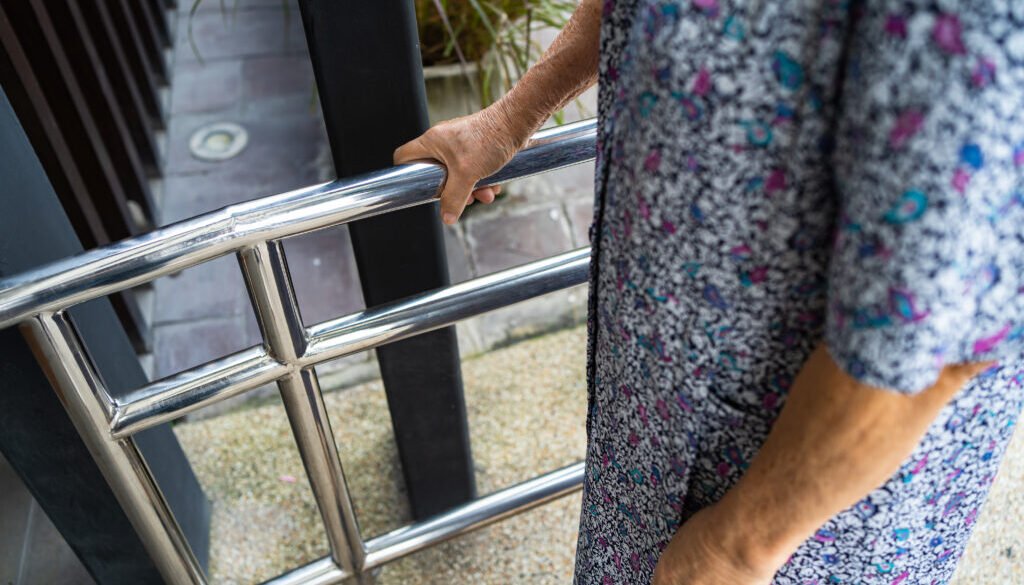 Close-up of hand grasping a railing