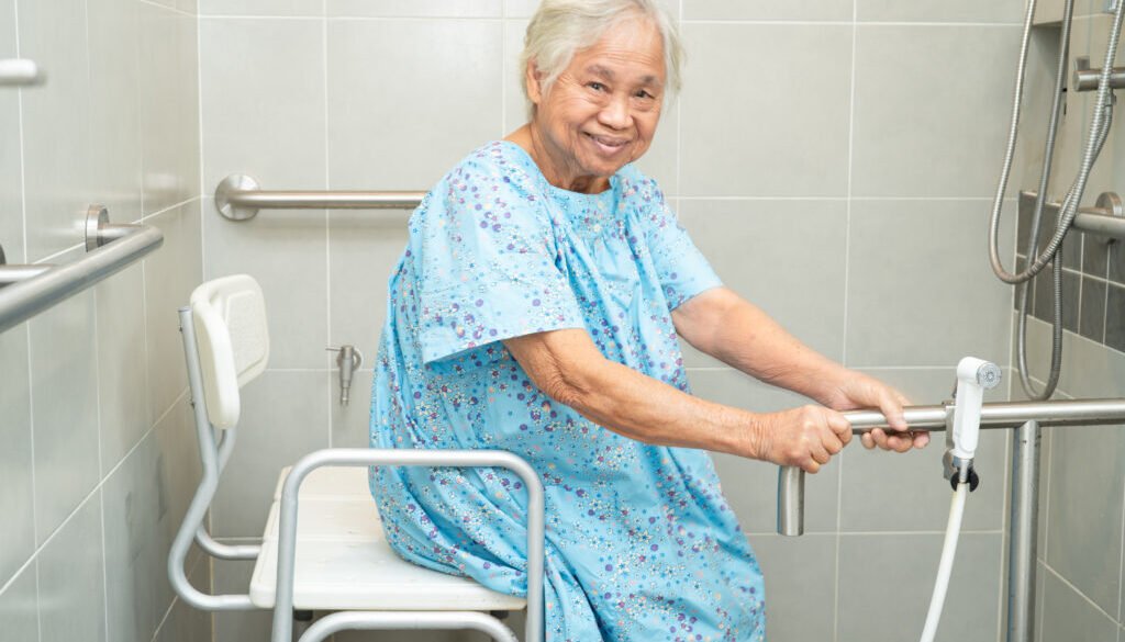 Senior woman sitting in a shower chair.