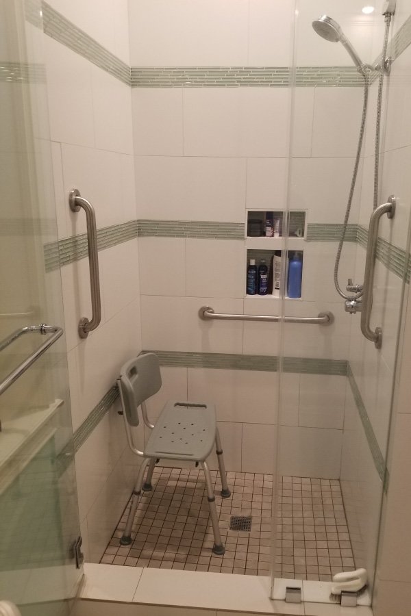Accessible shower with grab bars and seating