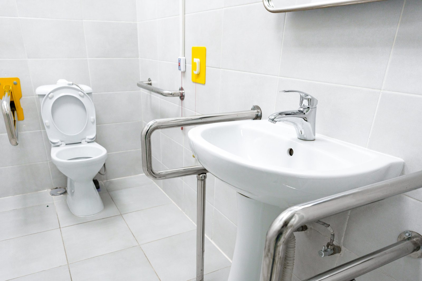 Accessible bathroom with toilet and sink.