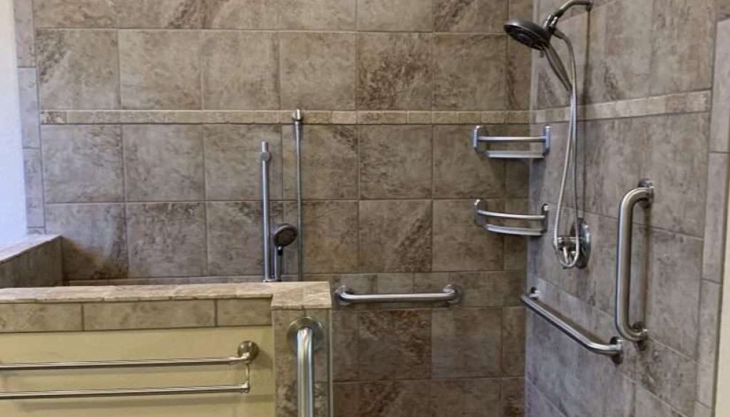 Accessible shower with grab bars and tiled walls
