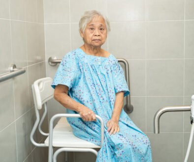 Elderly woman sitting on shower chair