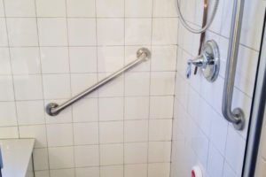 Accessible shower with grab bars and safety features.