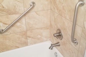 Modern bathtub with safety grab bars installed.
