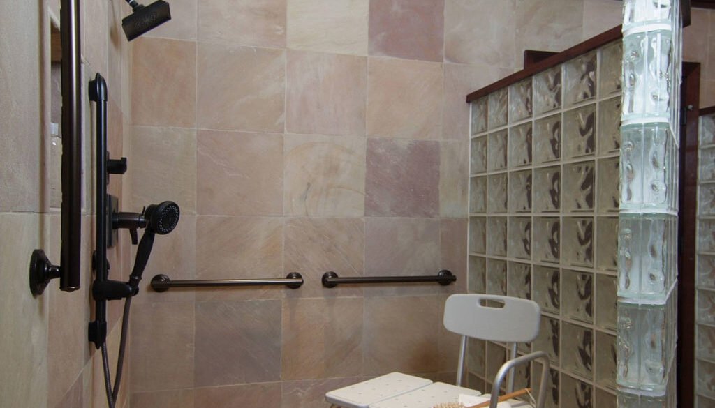 Accessible bathroom with shower and seating area.